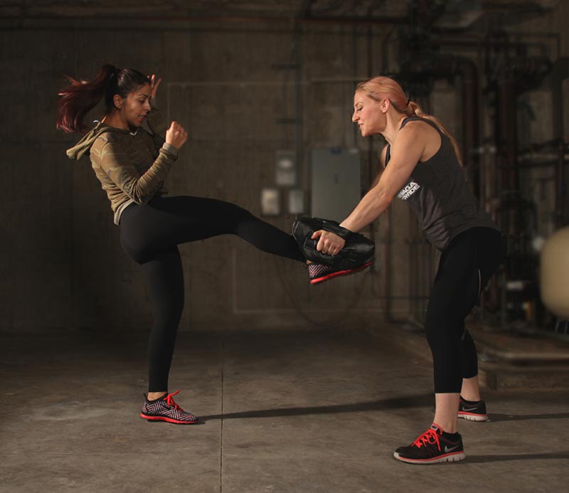 Self-defense techniques: Two women practicing Krav Maga groin kick