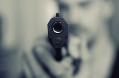 Pistol Pointed at Camera